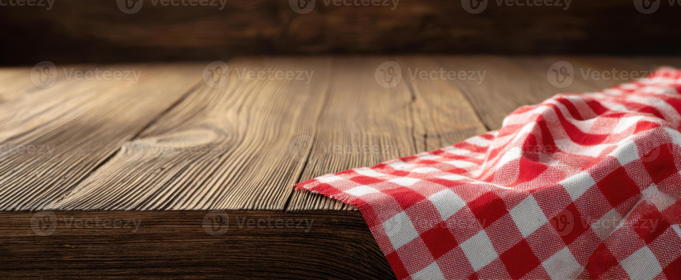 The beautiful checkered tablecloth draped over a rustic wooden surface. photo