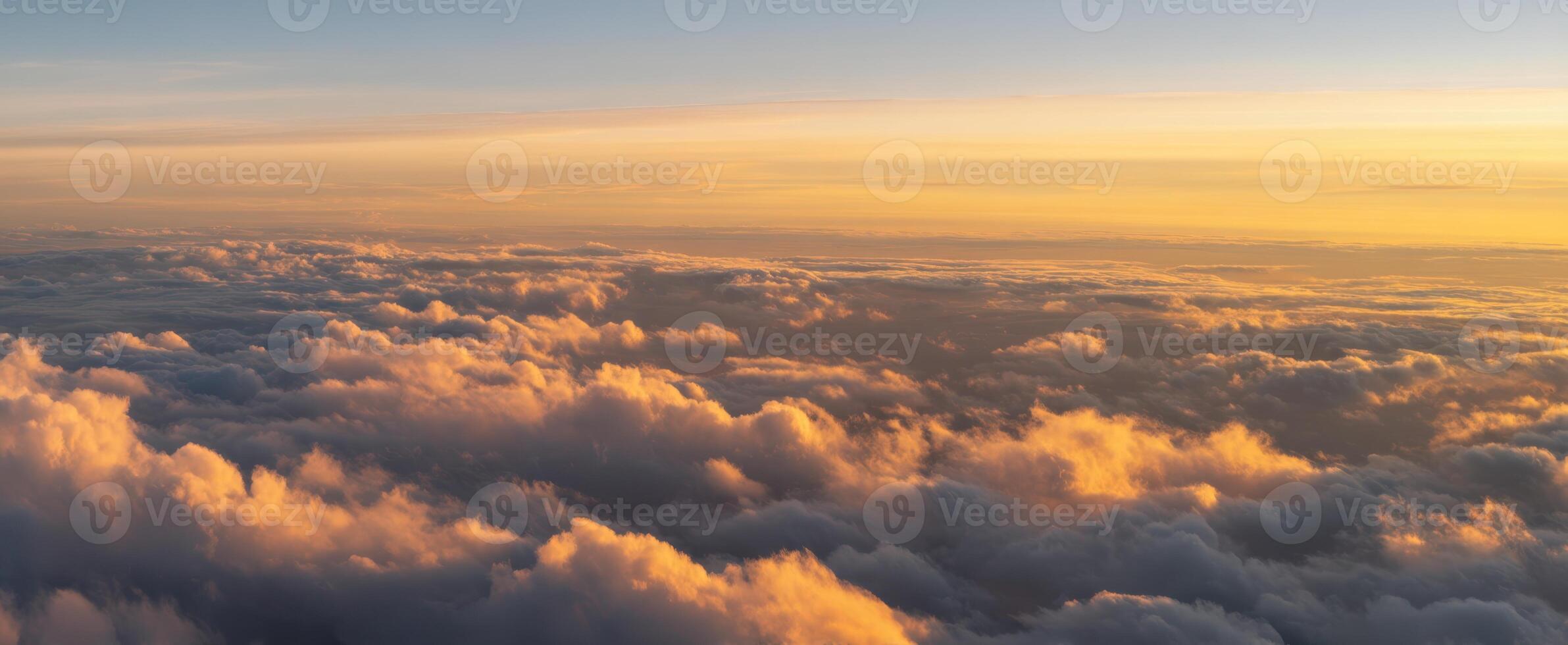 The Serene Sunset Over Fluffy Clouds Illuminated by Soft Light photo