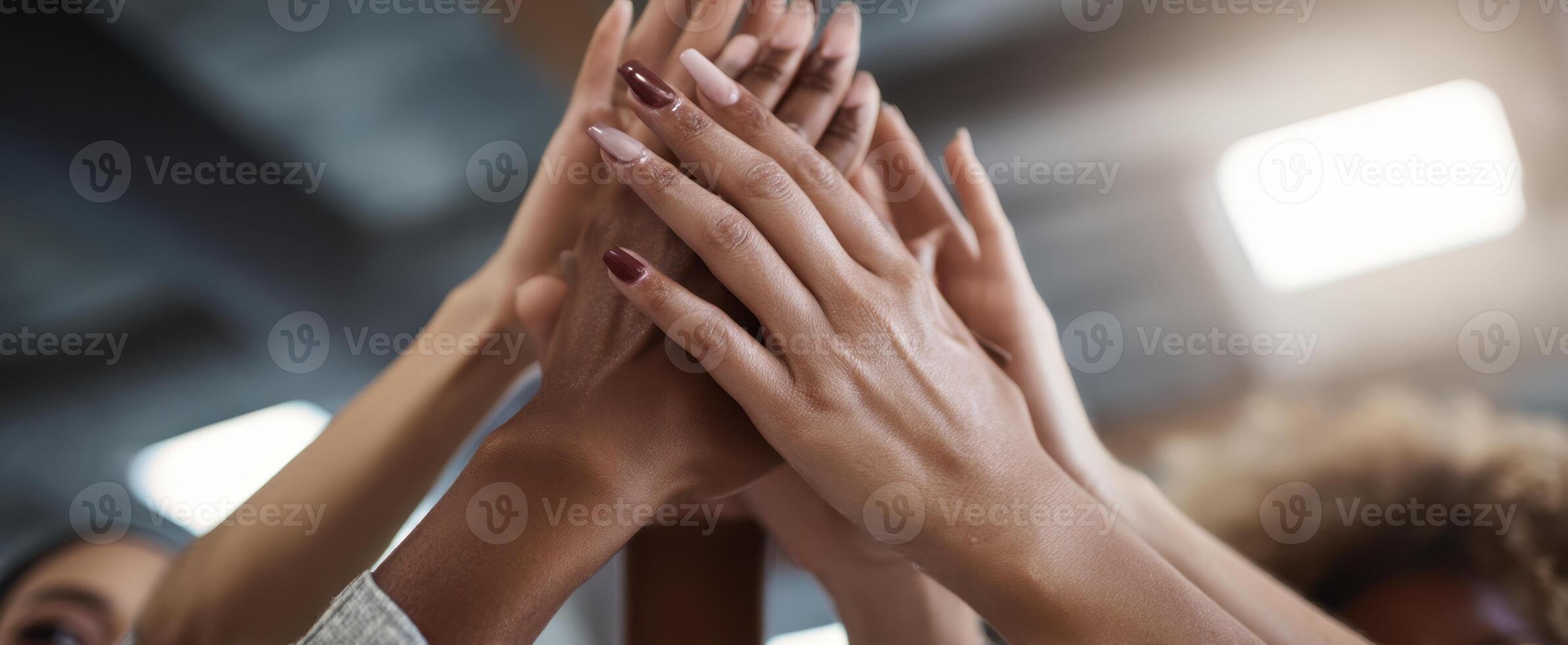 The hands of teamwork raised high in celebration and unity. photo