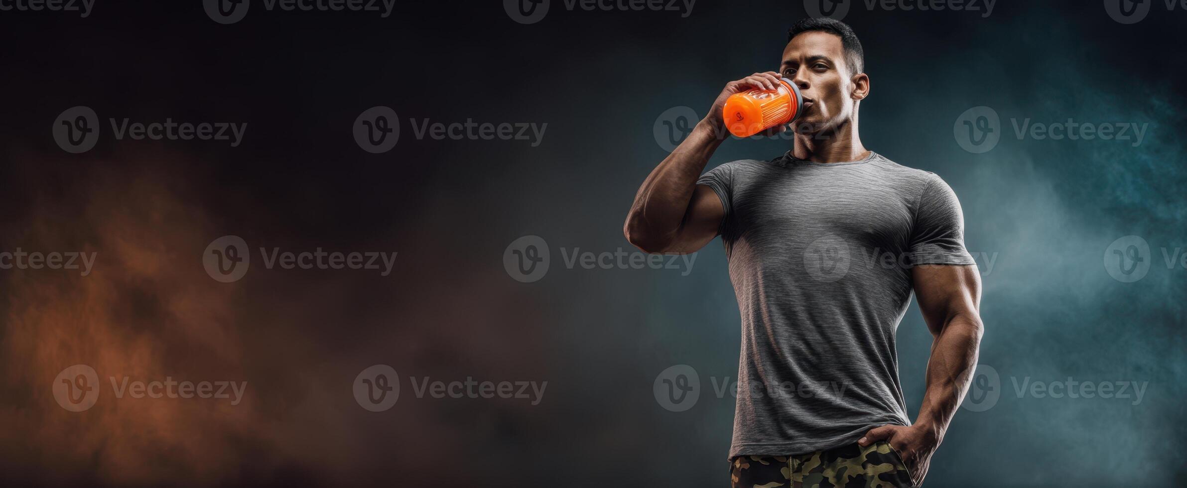 The muscular athlete enjoying a refreshing energy drink after a workout session. photo