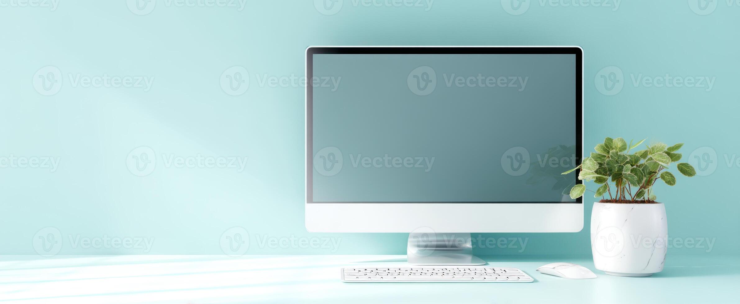 The modern computer setup with greenery for a stylish workspace ambiance. photo