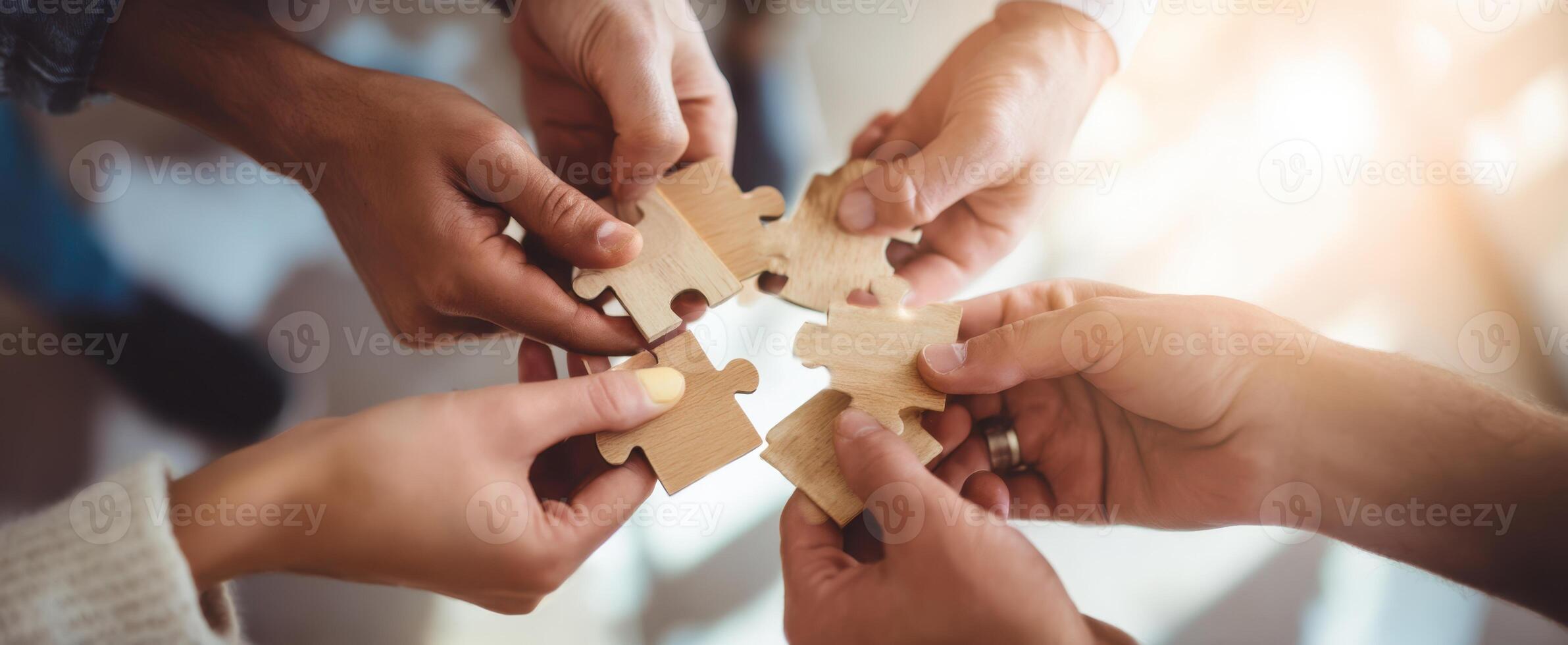 The Hands Collaborating to Complete a Puzzle for Teamwork Success photo