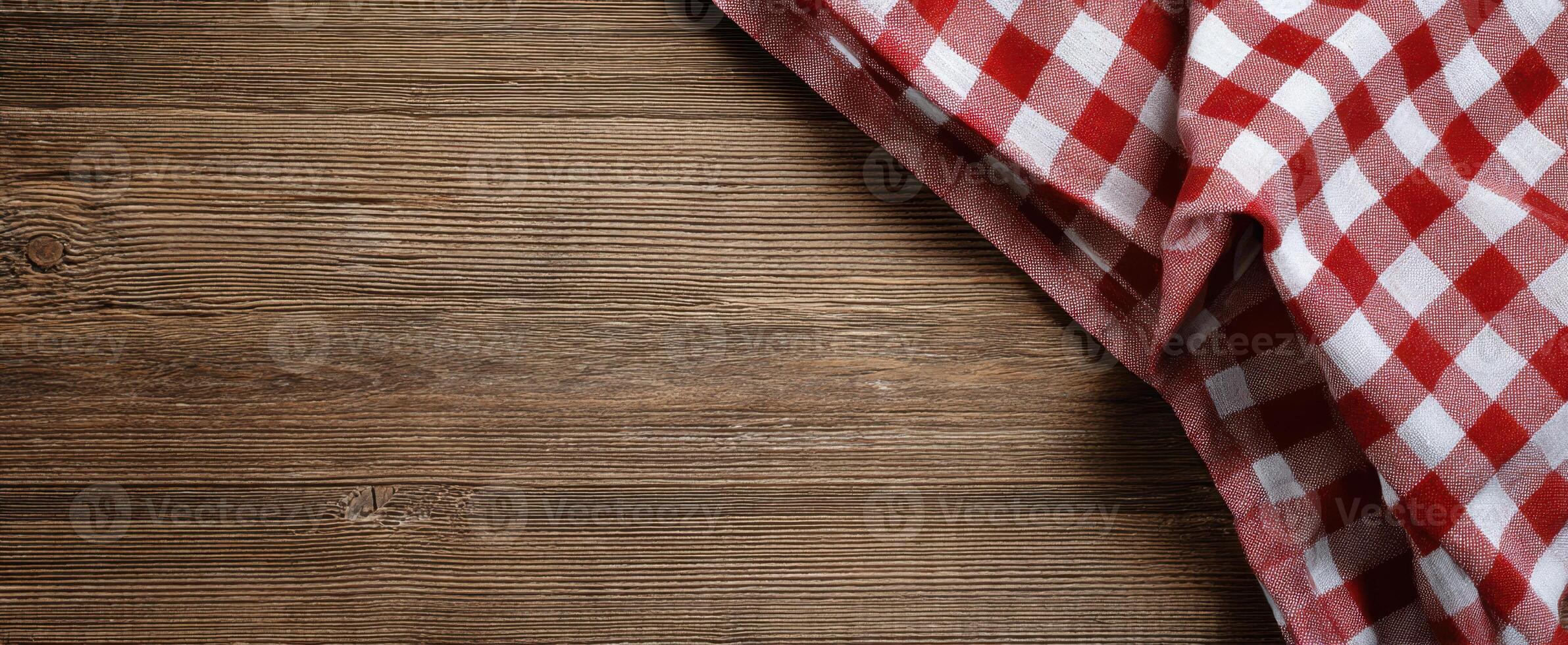 The checkered tablecloth adding charm to a rustic wooden surface. photo