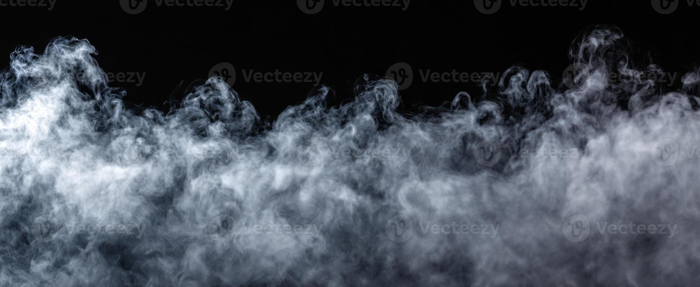 The swirling smoke creating an ethereal atmosphere against a dark background. photo