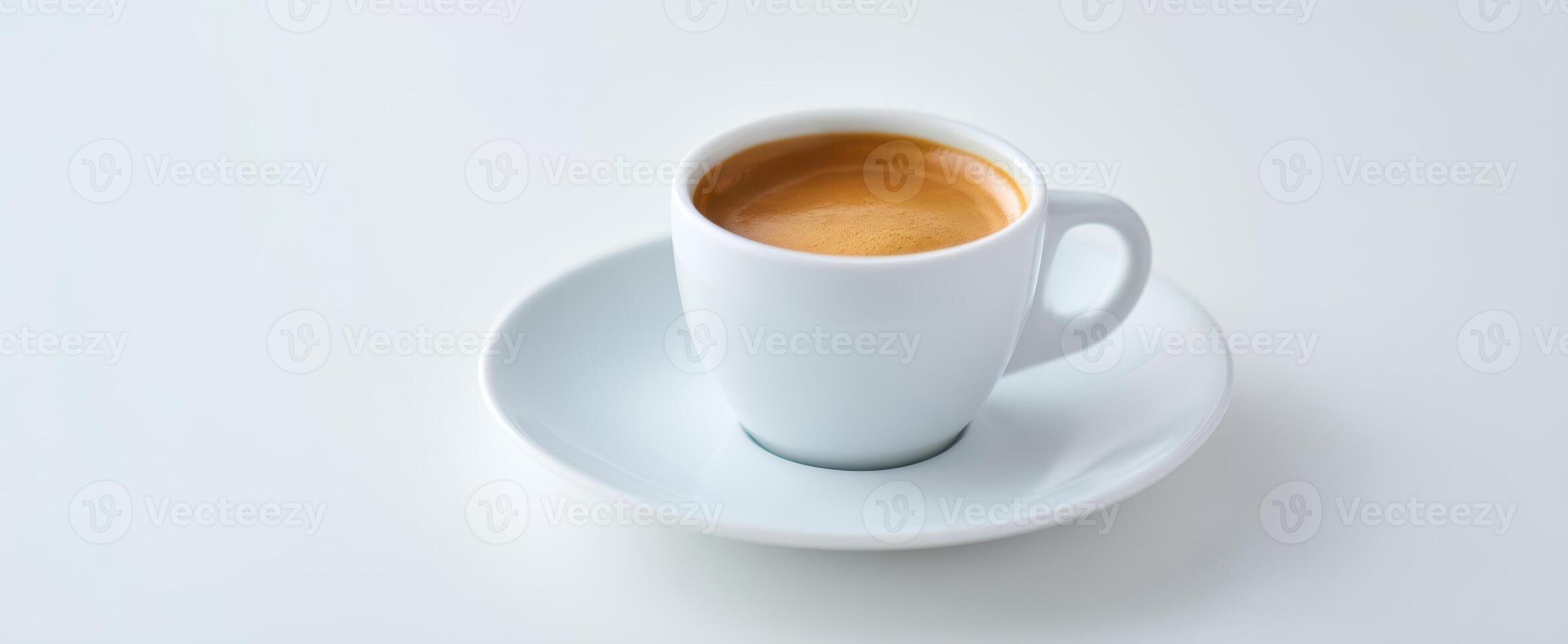The elegant cup of espresso served on a minimalist white saucer. photo