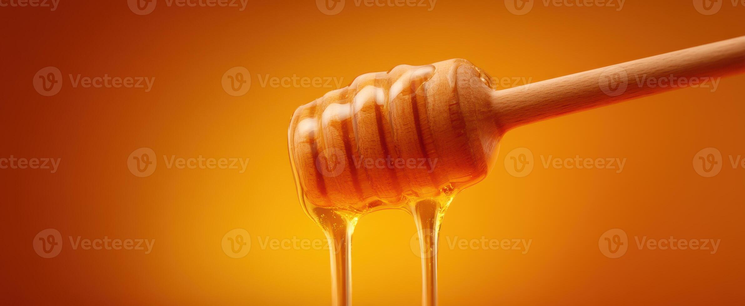 The Honey Dipper Dripping Golden Sweetness on a Warm Background photo