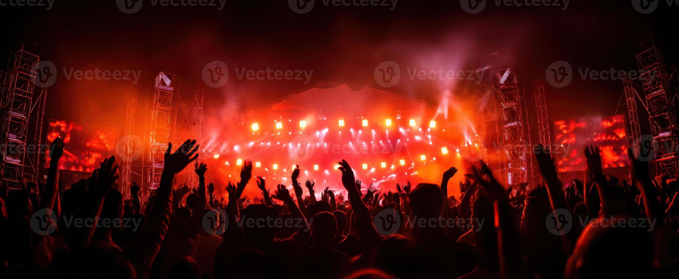 The vibrant atmosphere of a lively concert with energetic audience participation. photo