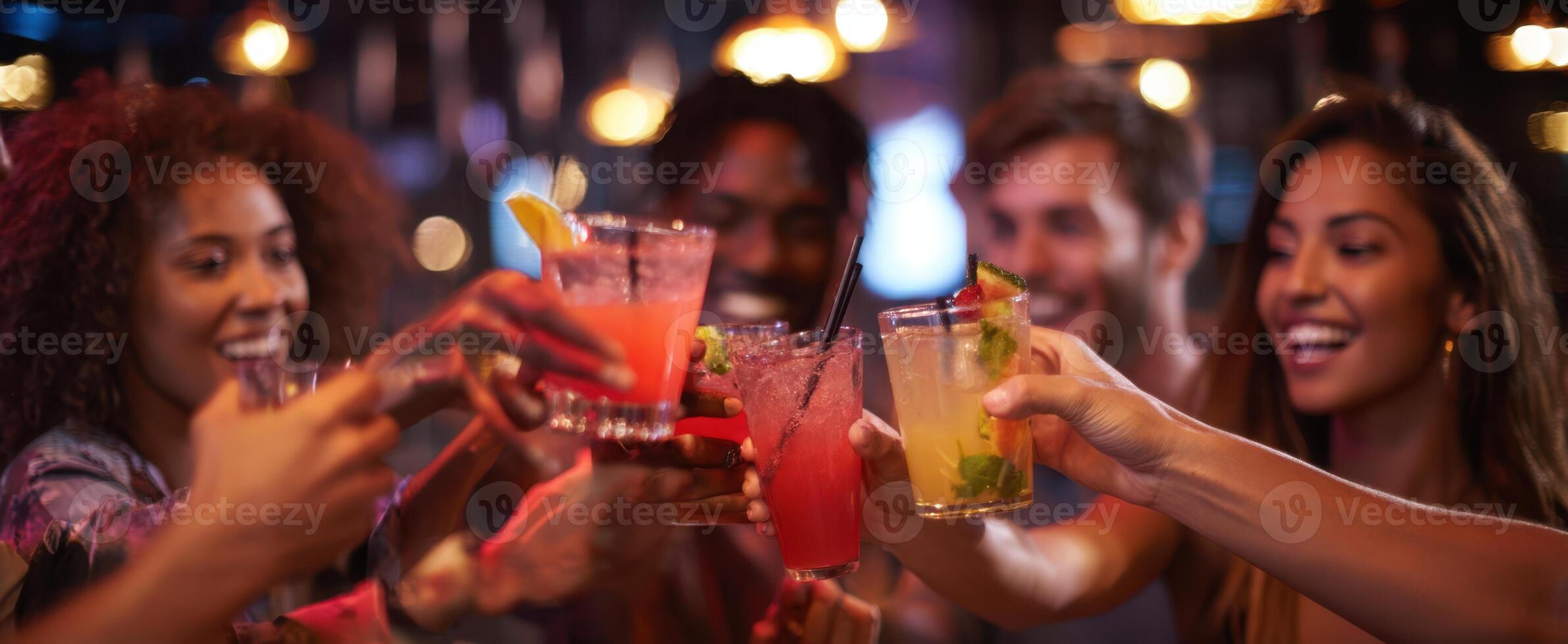 The joyful toast with colorful cocktails among friends at a lively party. photo