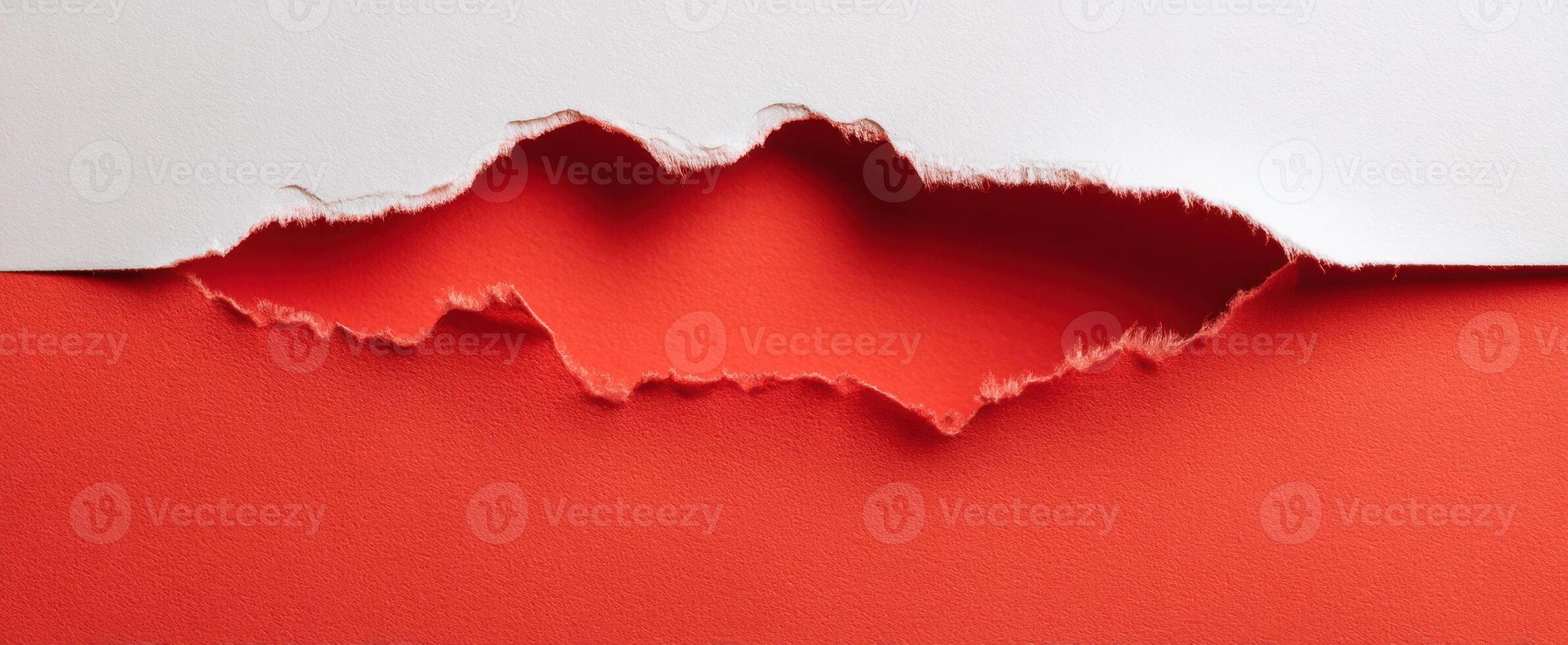 The Torn Paper Revealing Bold Red Background in Artistic Composition photo