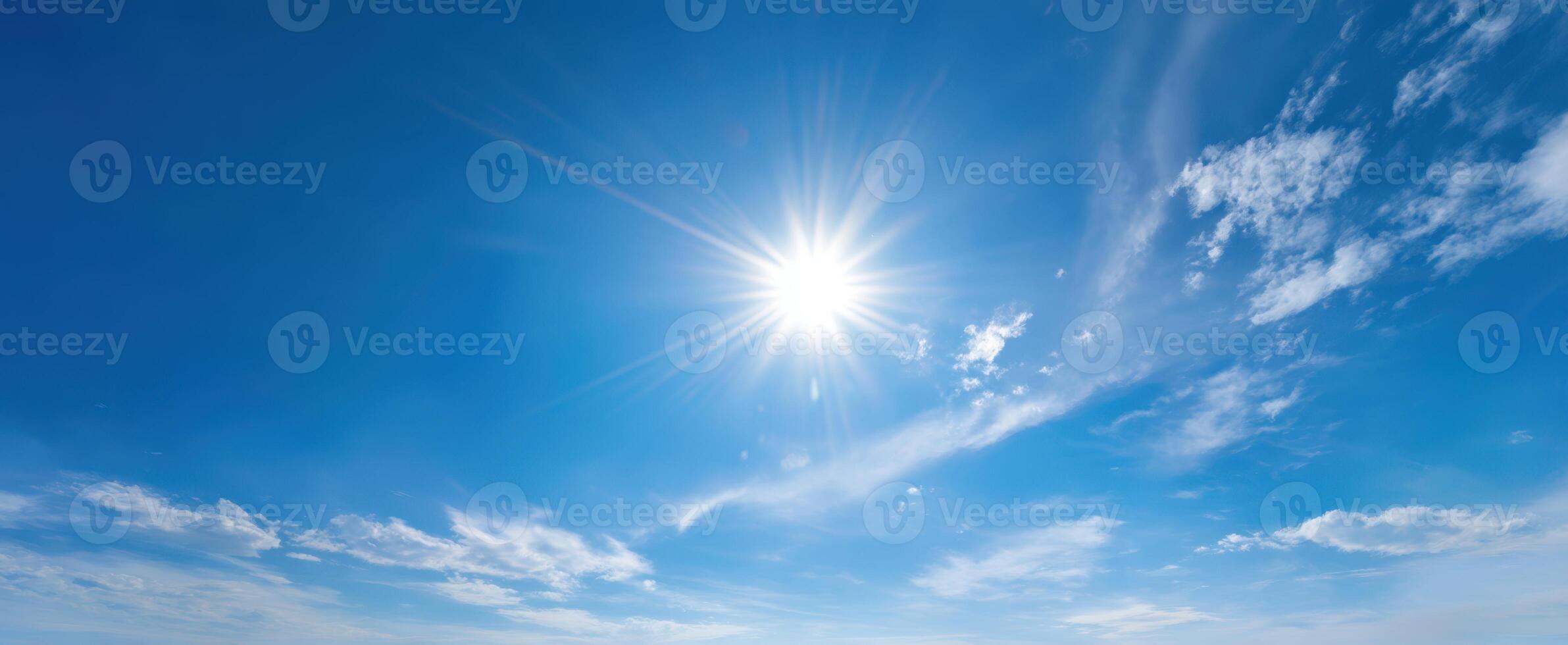 The Radiant Sun Illuminating a Clear Blue Sky with Wispy Clouds photo