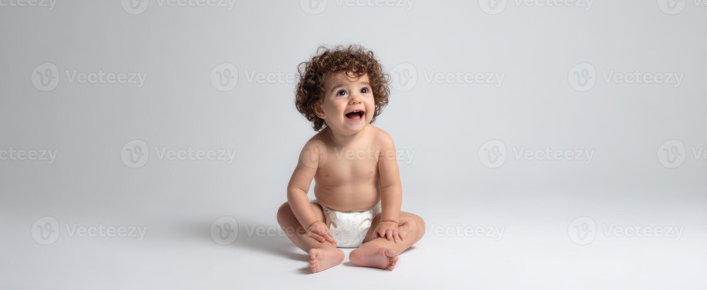 The joyful baby sitting and smiling in a minimalistic, serene environment. photo