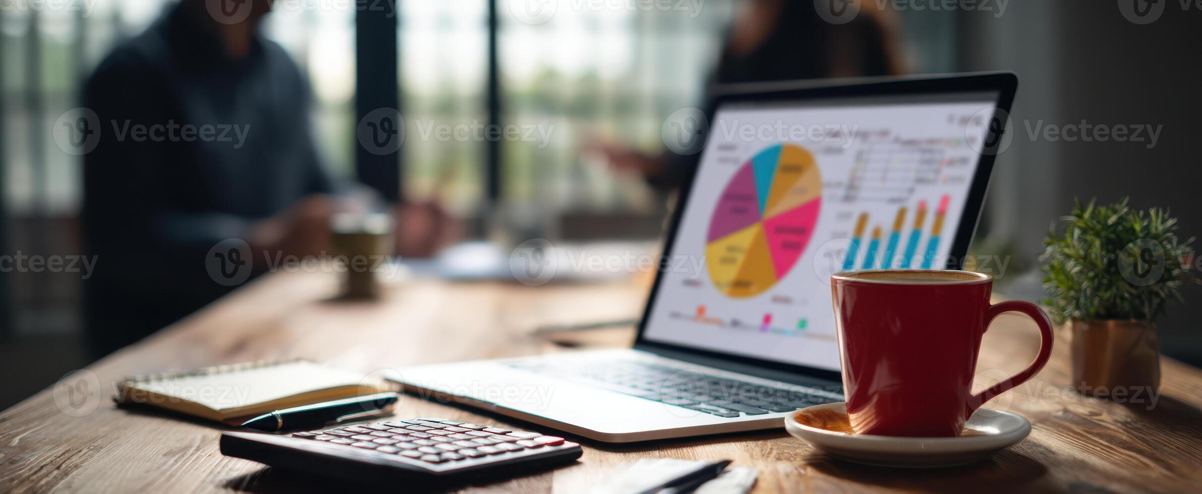 The laptop displaying colorful charts on a modern workspace table. photo