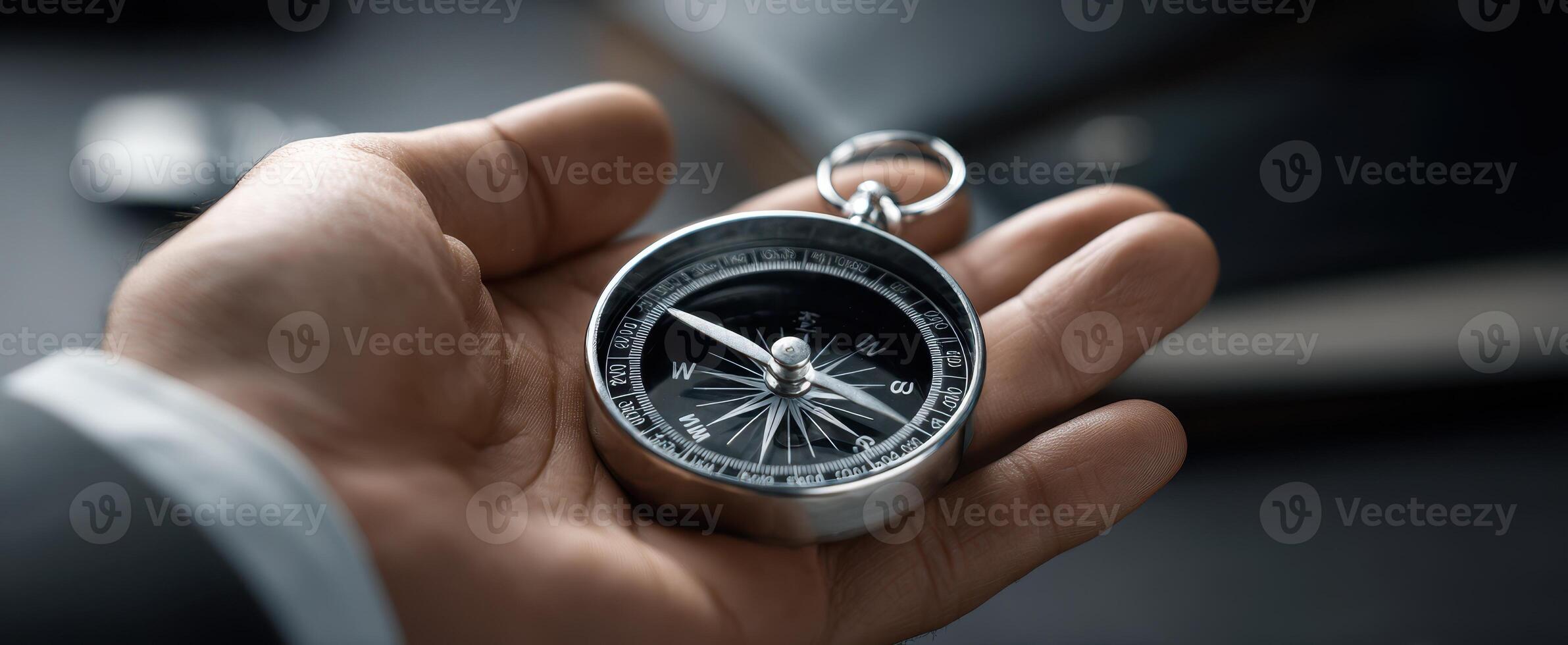 The stylish compass held in a hand symbolizing direction and exploration. photo