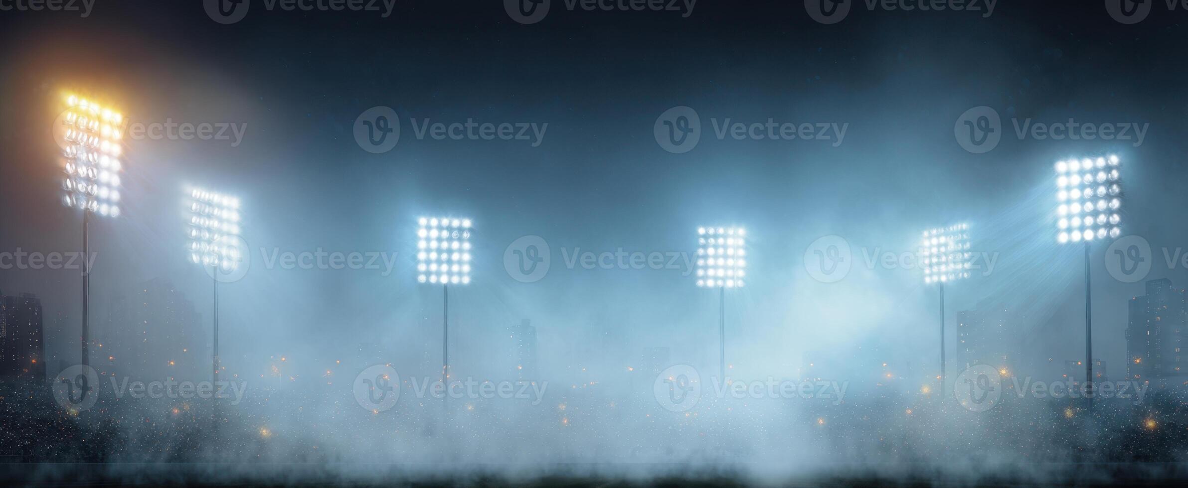 The illuminated sports stadium glowing under a mysterious fog at night. photo