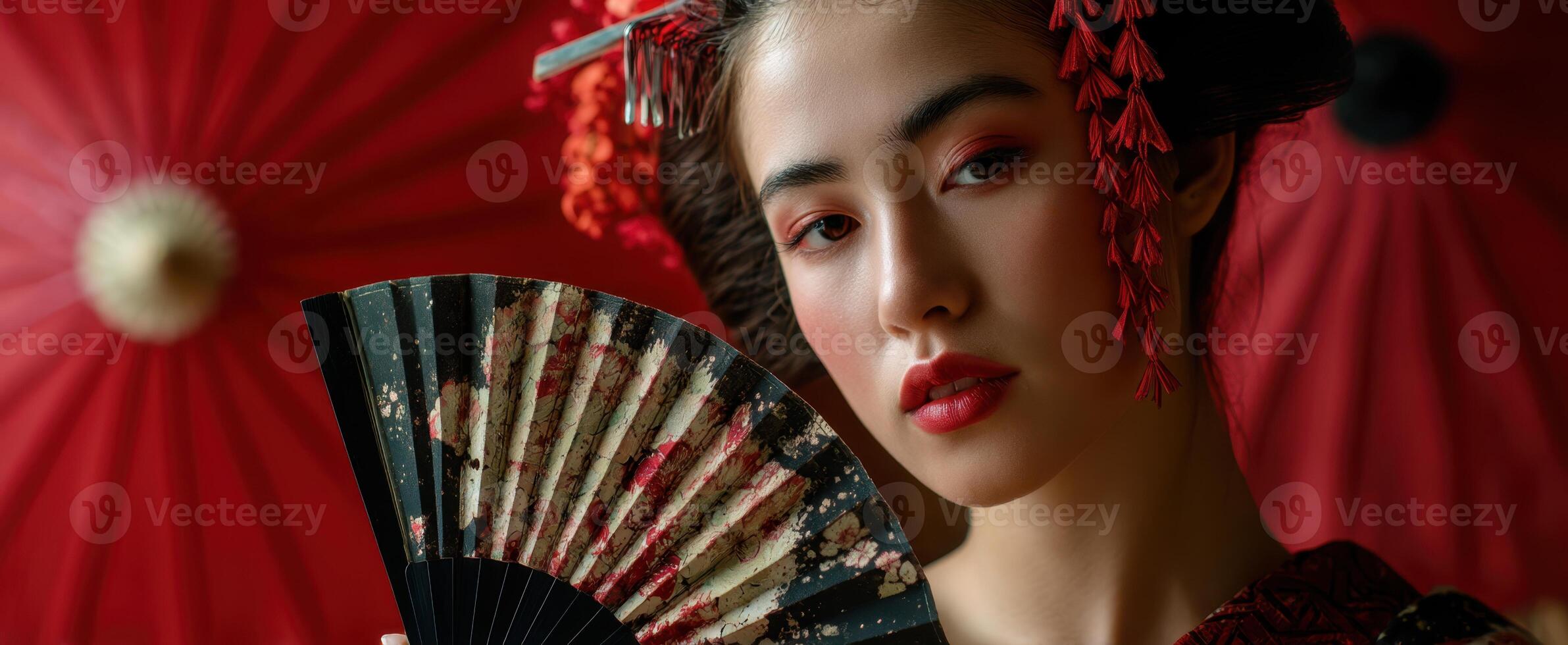 The elegant model holding a decorative fan in a vibrant traditional setting. photo