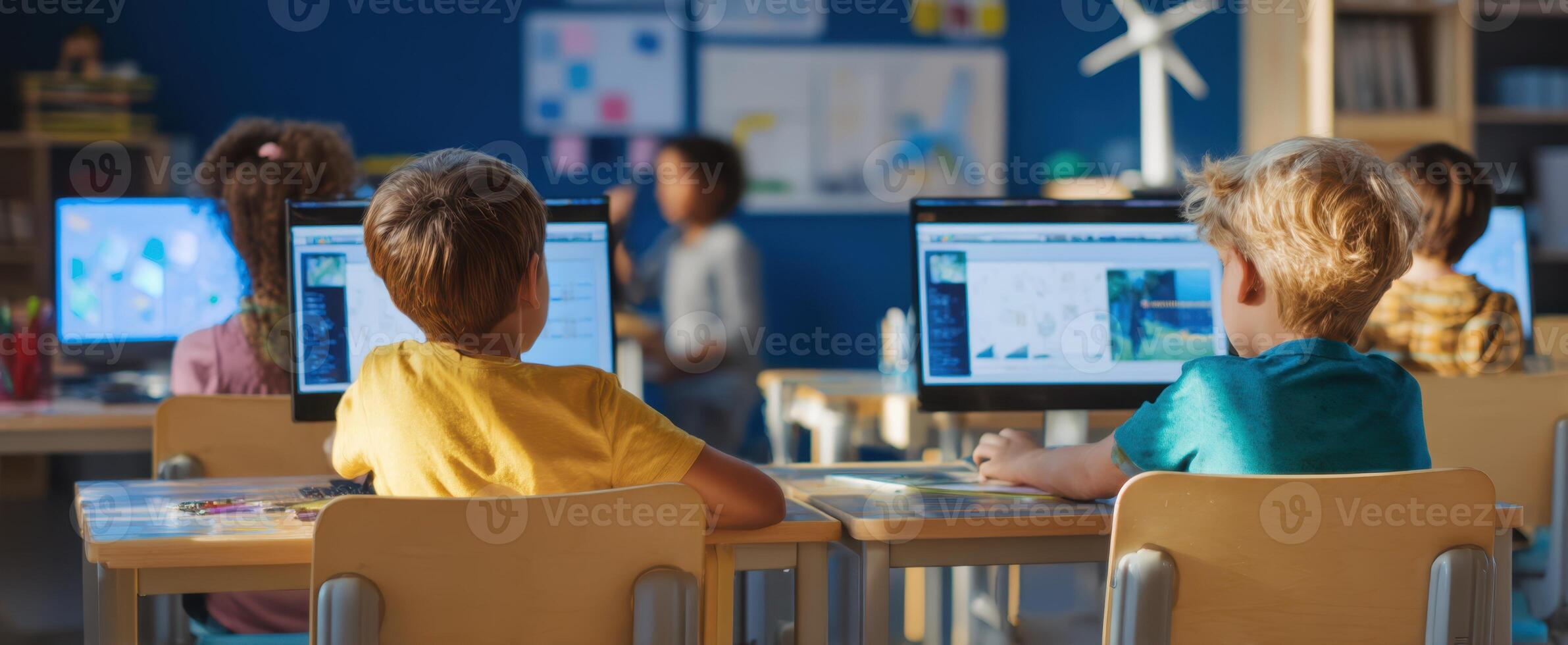 The children engaged in a computer learning activity in a modern classroom setting. photo