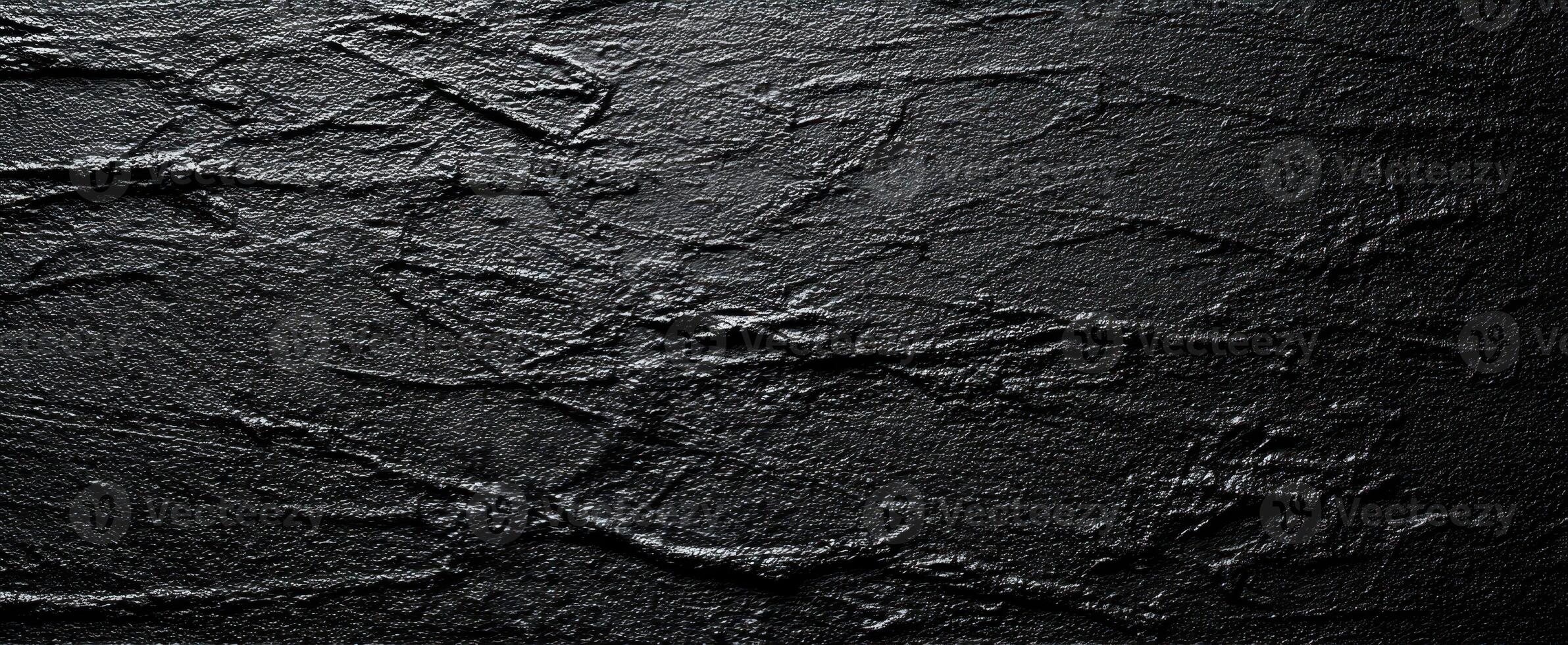 The textured black surface with intricate patterns and minimalistic design. photo