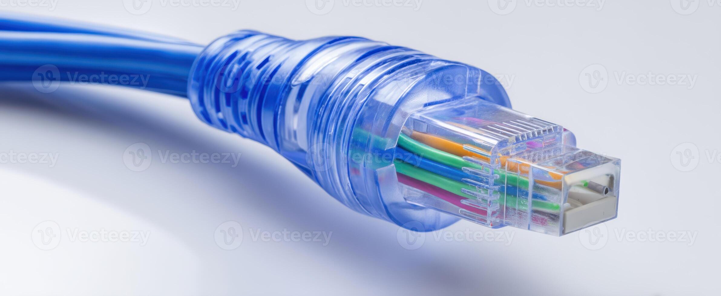 The blue Ethernet cable with transparent connector for high-speed internet connection. photo