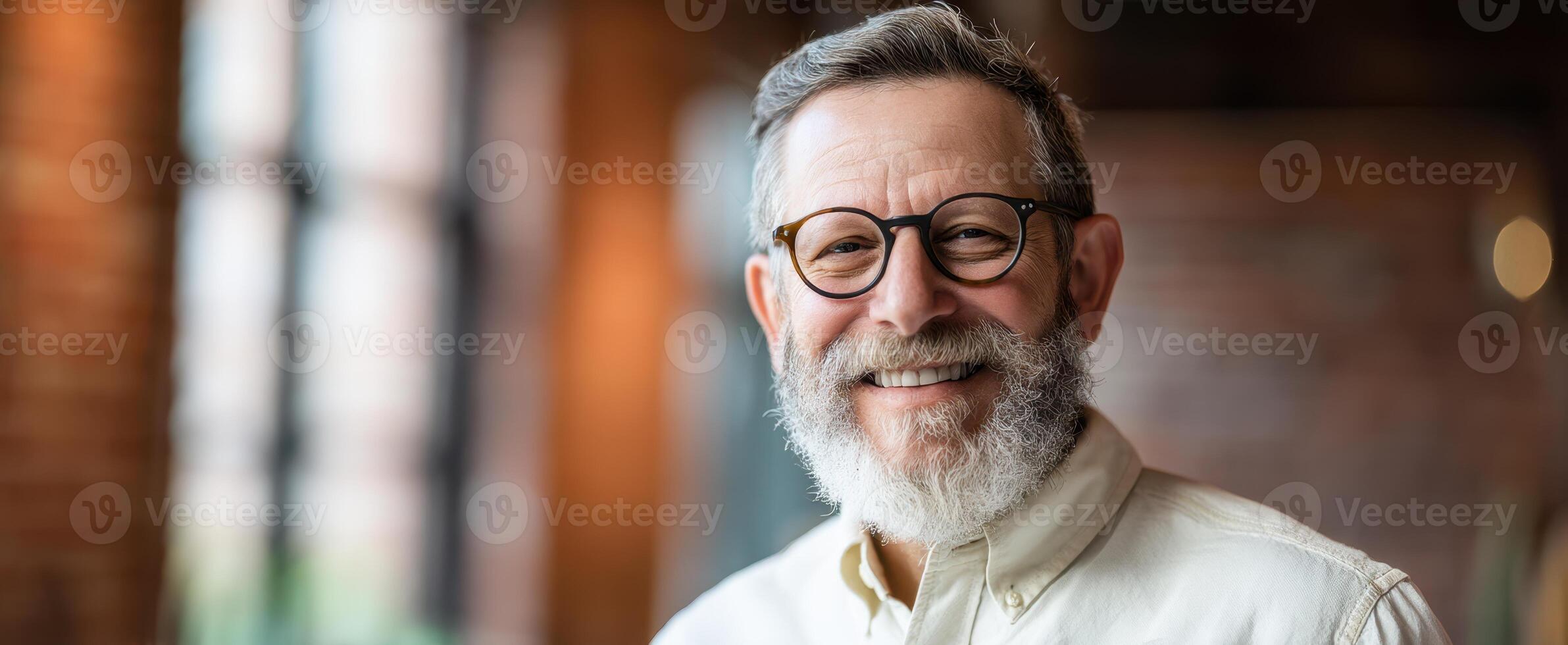 The smiling man with glasses showcasing confidence and warmth in a modern setting photo
