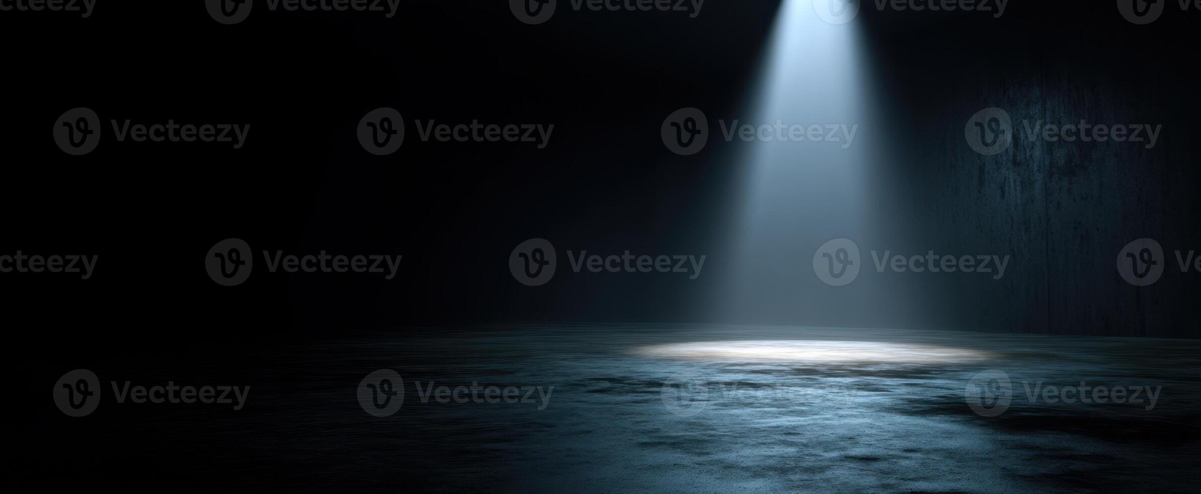 The spotlight illuminating an empty space in a dark environment. photo