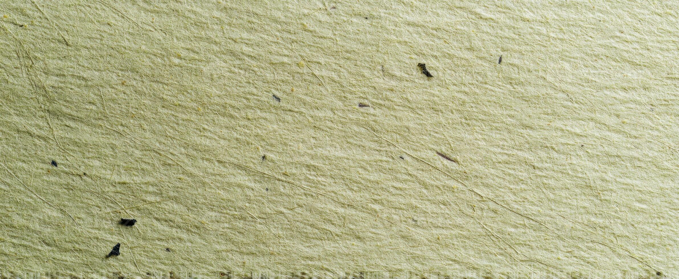 The textured surface of handmade paper with unique natural patterns and flecks. photo