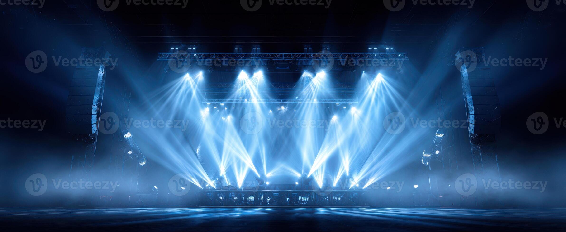 The spectacular stage illuminated by dynamic blue lighting in a concert setting. photo
