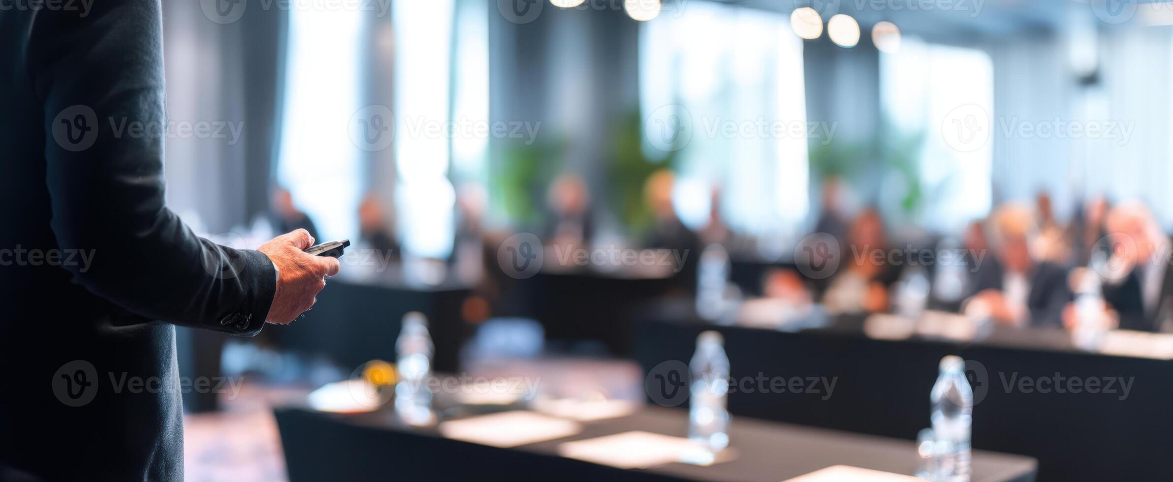 The speaker captivating the audience during a corporate conference presentation. photo