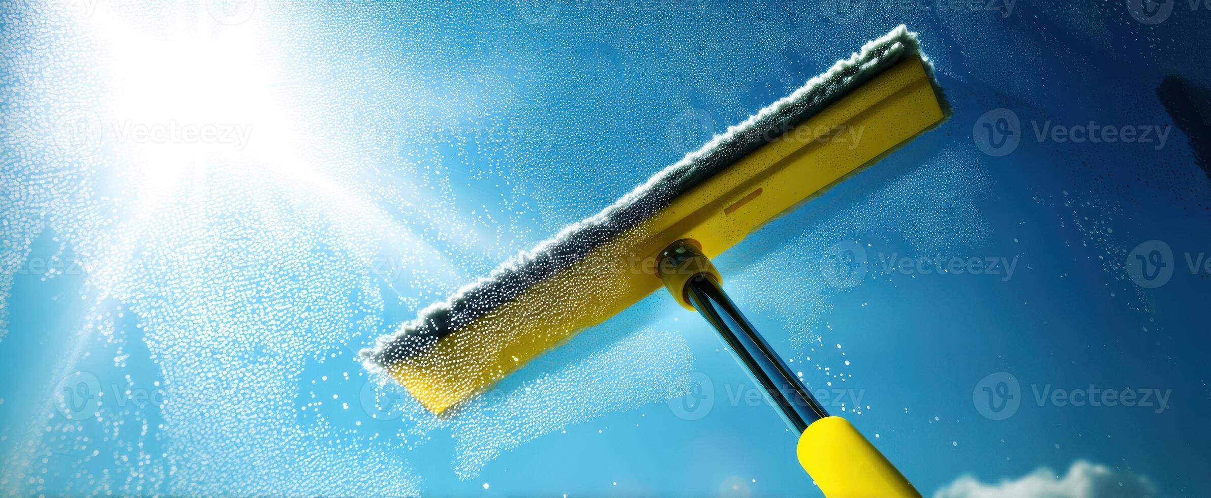 The Squeegee Cleaning a Window Under Bright Sunlight for a Crystal Clear View photo