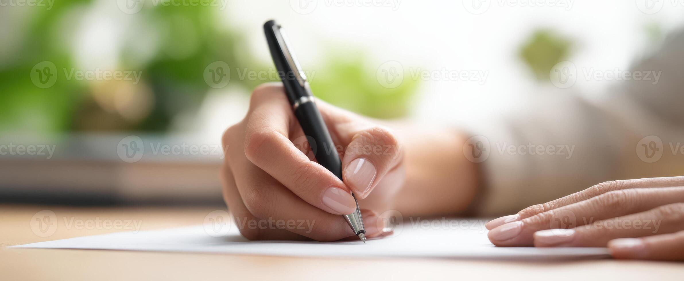 The hand writing with a pen on a piece of paper in a calm workspace. photo