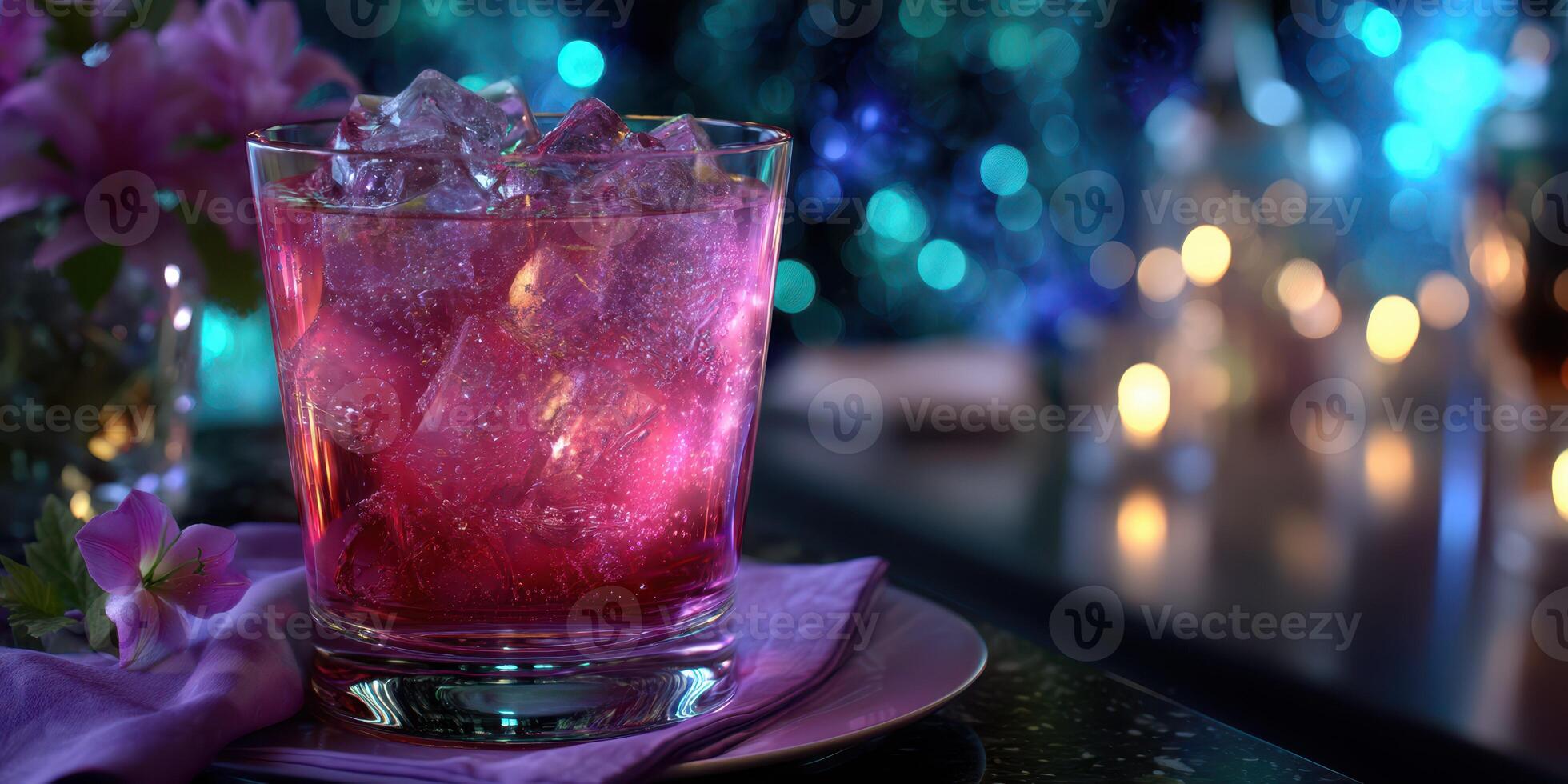 Refreshing cocktail sits on a styled table surrounded by colorful lights and floral decorations during an evening gathering photo