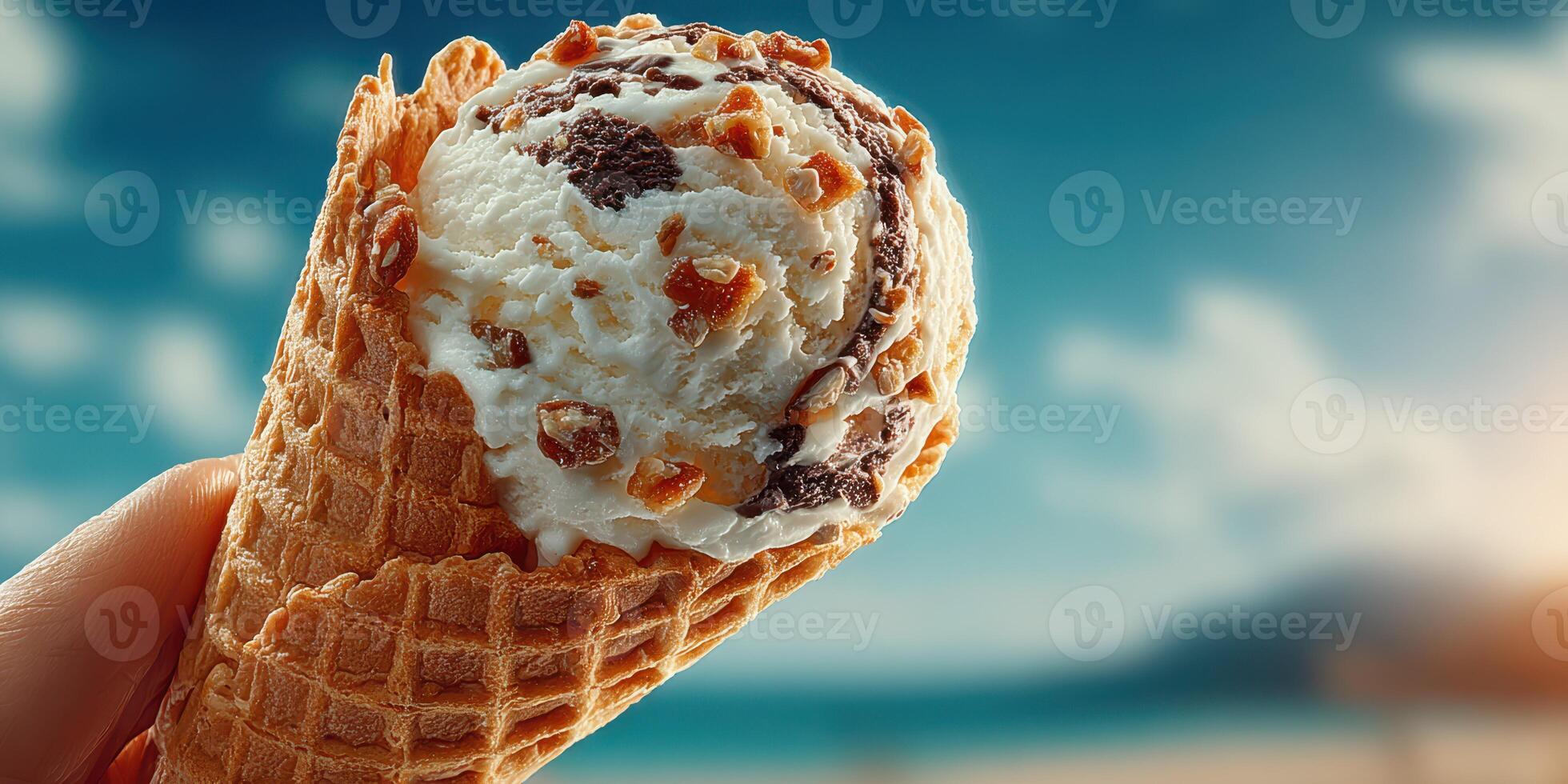 Enjoying a delicious ice cream cone at the beach on a sunny day with clear skies and a relaxed atmosphere photo