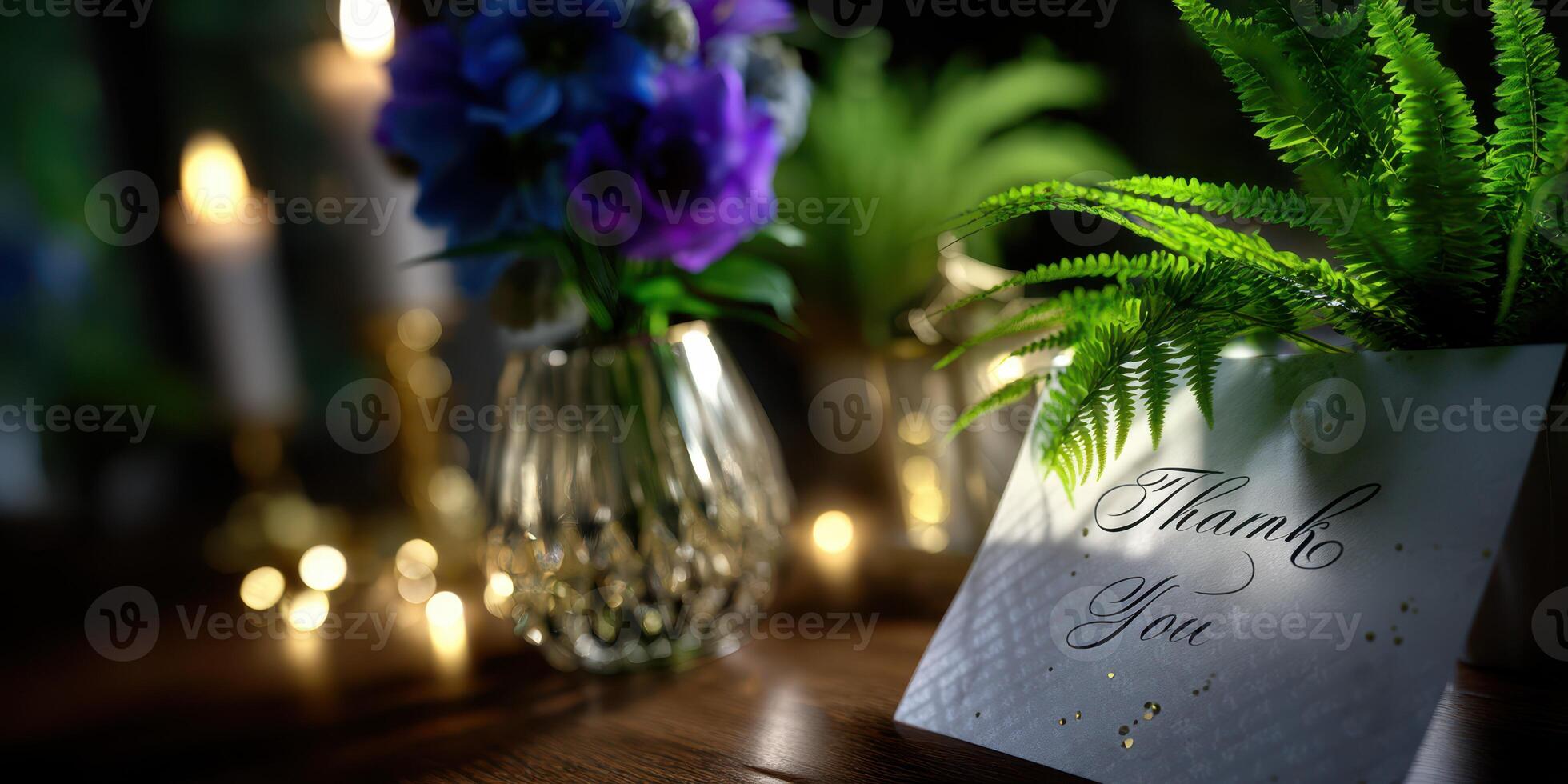 Elegant thank you card and flowers with candles softly illuminating a cozy indoor setting photo