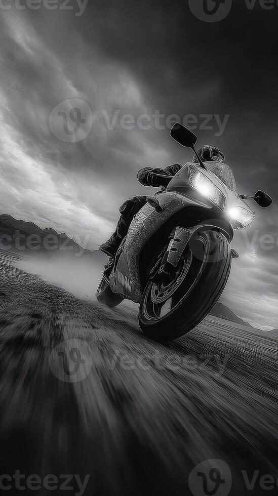 Motorcycle rider speeds through rugged terrain under dramatic clouds at dusk photo
