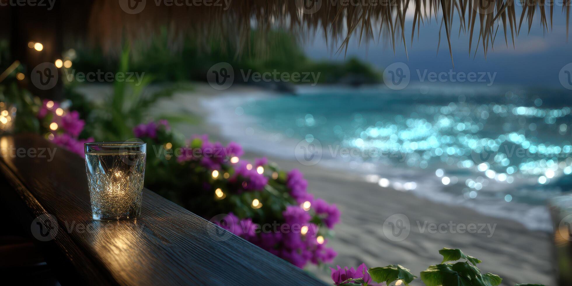 Evening by the beach with a sparkling drink and vibrant flowers in a tranquil coastal setting photo