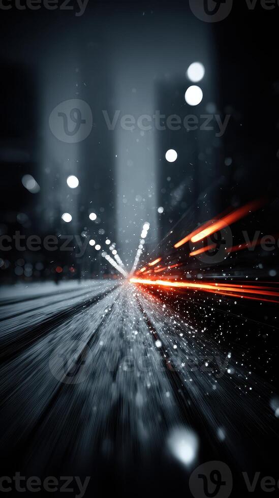Nighttime city streets illuminated by light trails from passing vehicles during a snowstorm photo