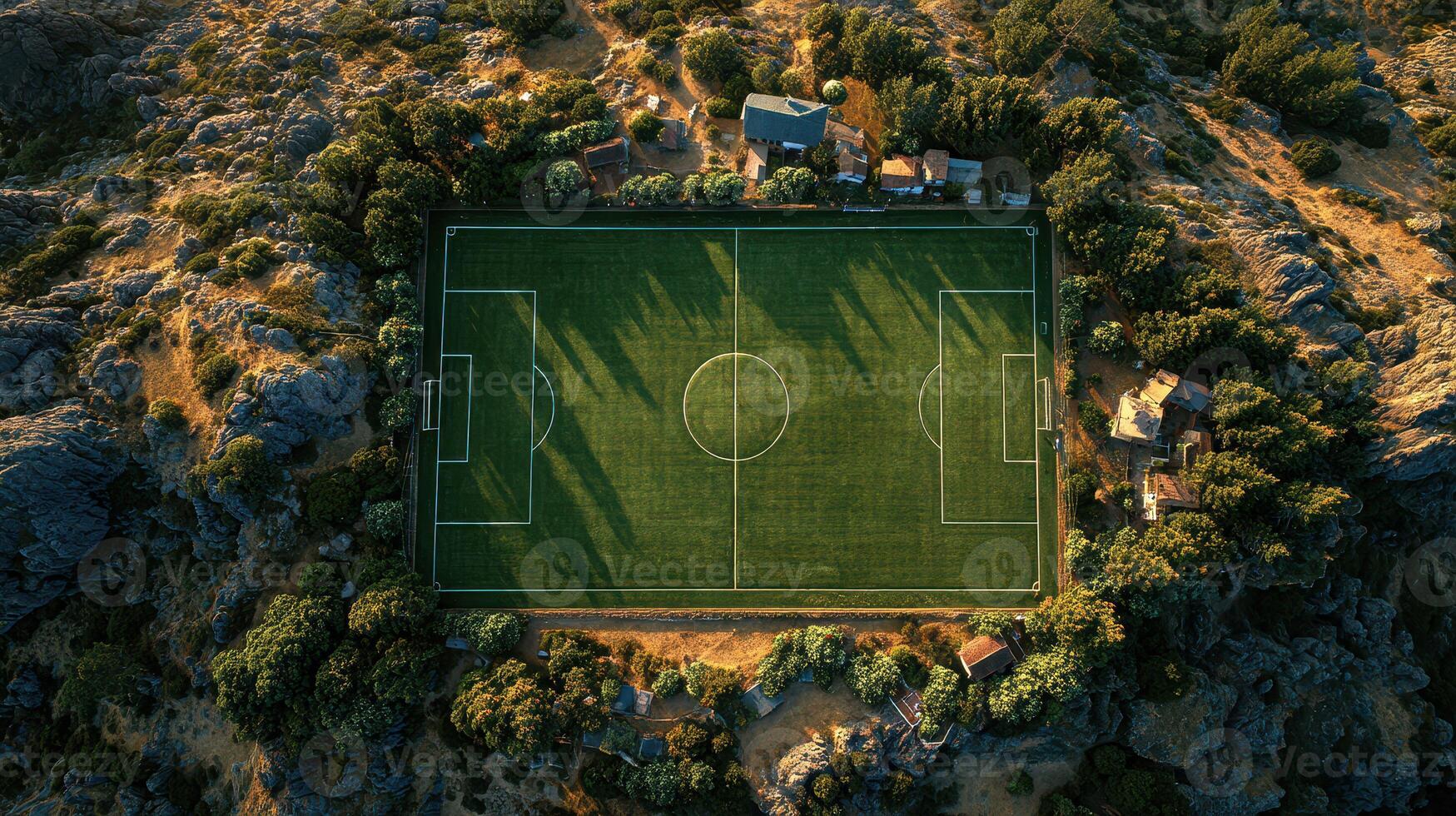 Expansive soccer field surrounded by nature in a serene location during sunset photo