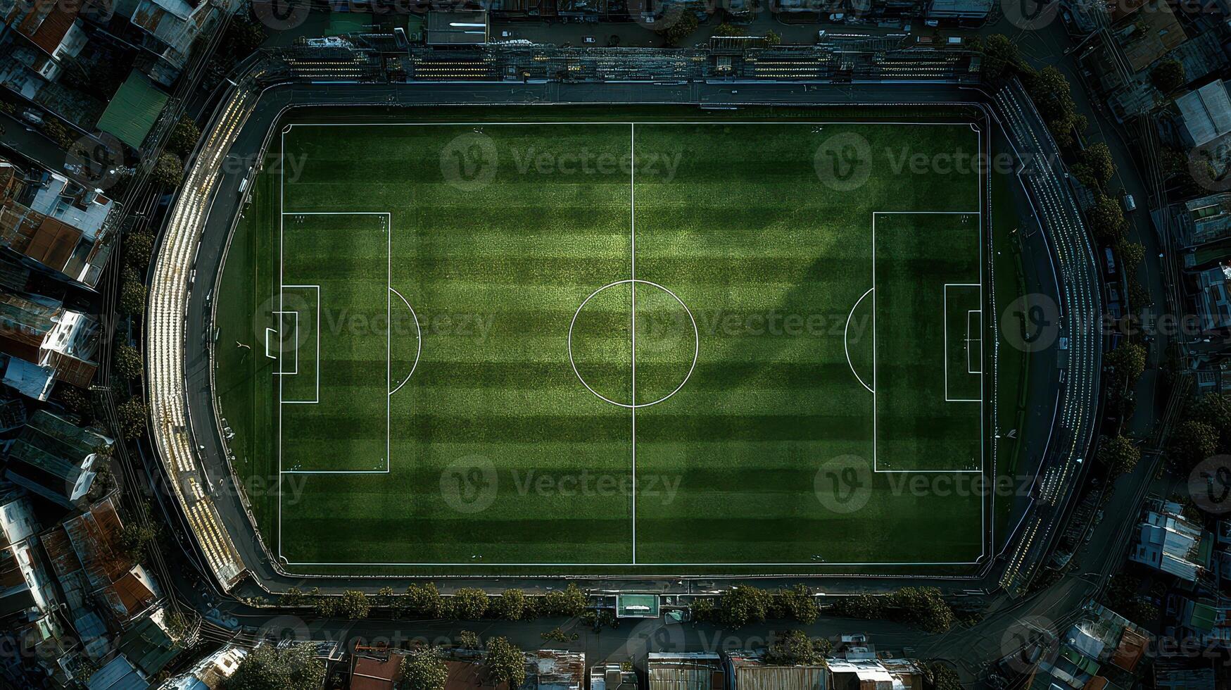 Stadium field viewed from above on a bright day with sunlight casting shadows on the grass photo