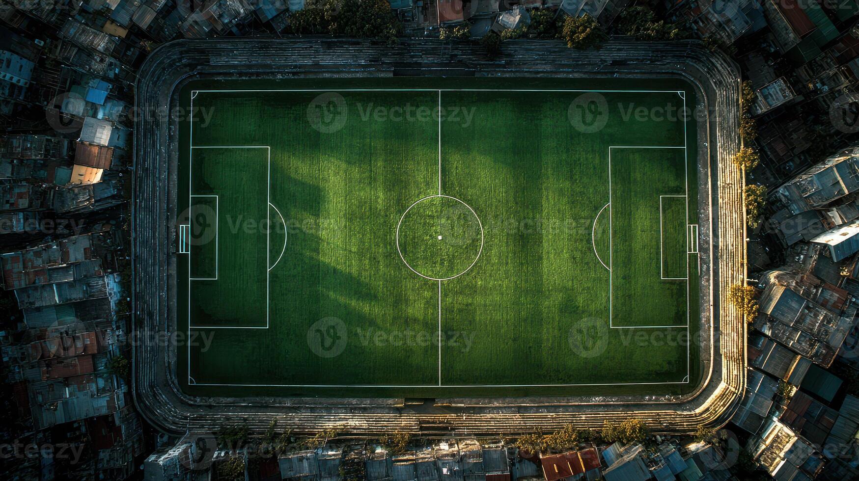 Soccer field surrounded by urban landscape viewed from above during late afternoon light photo