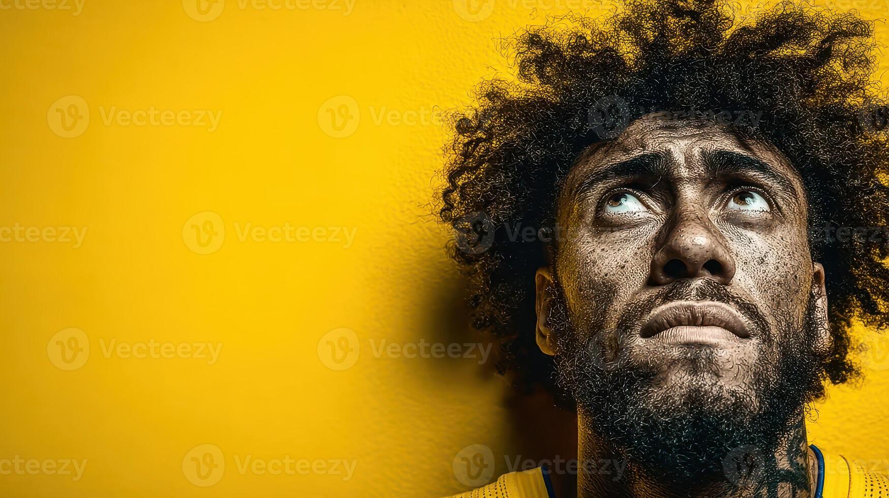 Athlete showing determination and intensity with a focused expression against a bright yellow background photo
