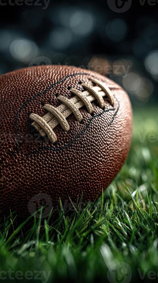 Close-up of a football resting on lush green grass in a well-lit stadium during a game photo