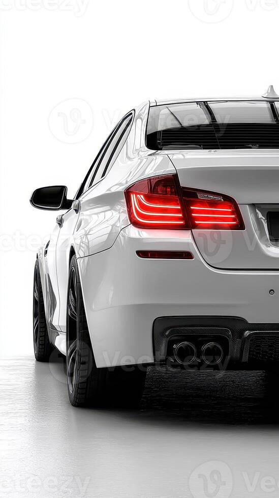 Sleek white car displayed in modern showroom highlighting design features and LED taillights photo