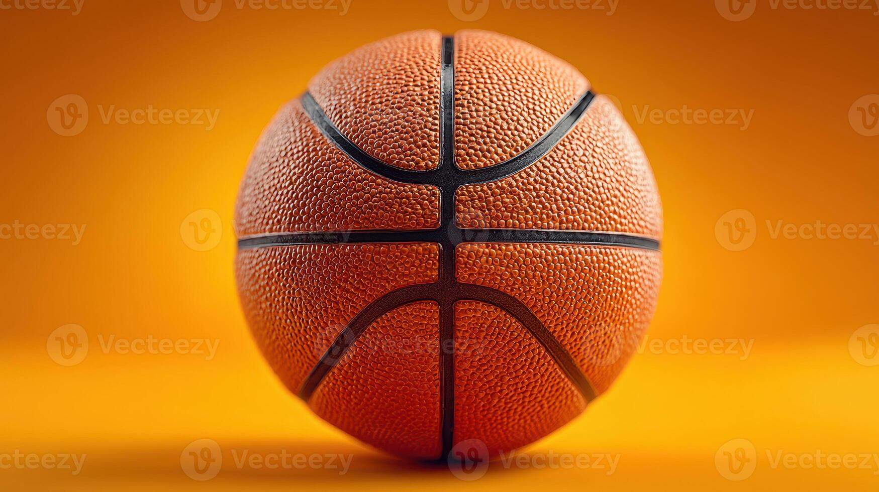 Bright orange basketball with textured surface on a vibrant yellow-orange background showcasing the essence of the sport photo