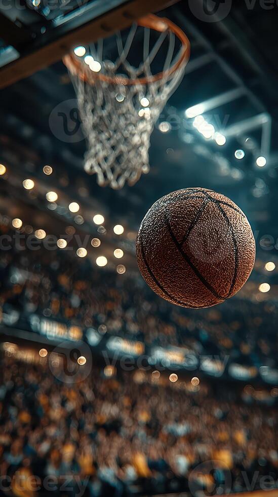Basketball flies through the air towards the hoop in an energetic arena filled with cheering fans at a night game photo