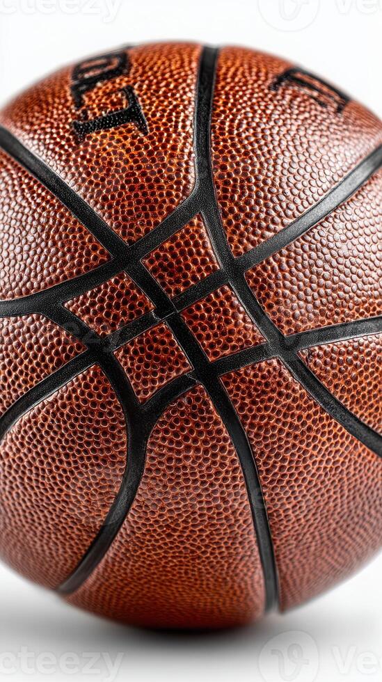 Basketball resting on white surface highlighting texture and details of design at indoor sports venue photo