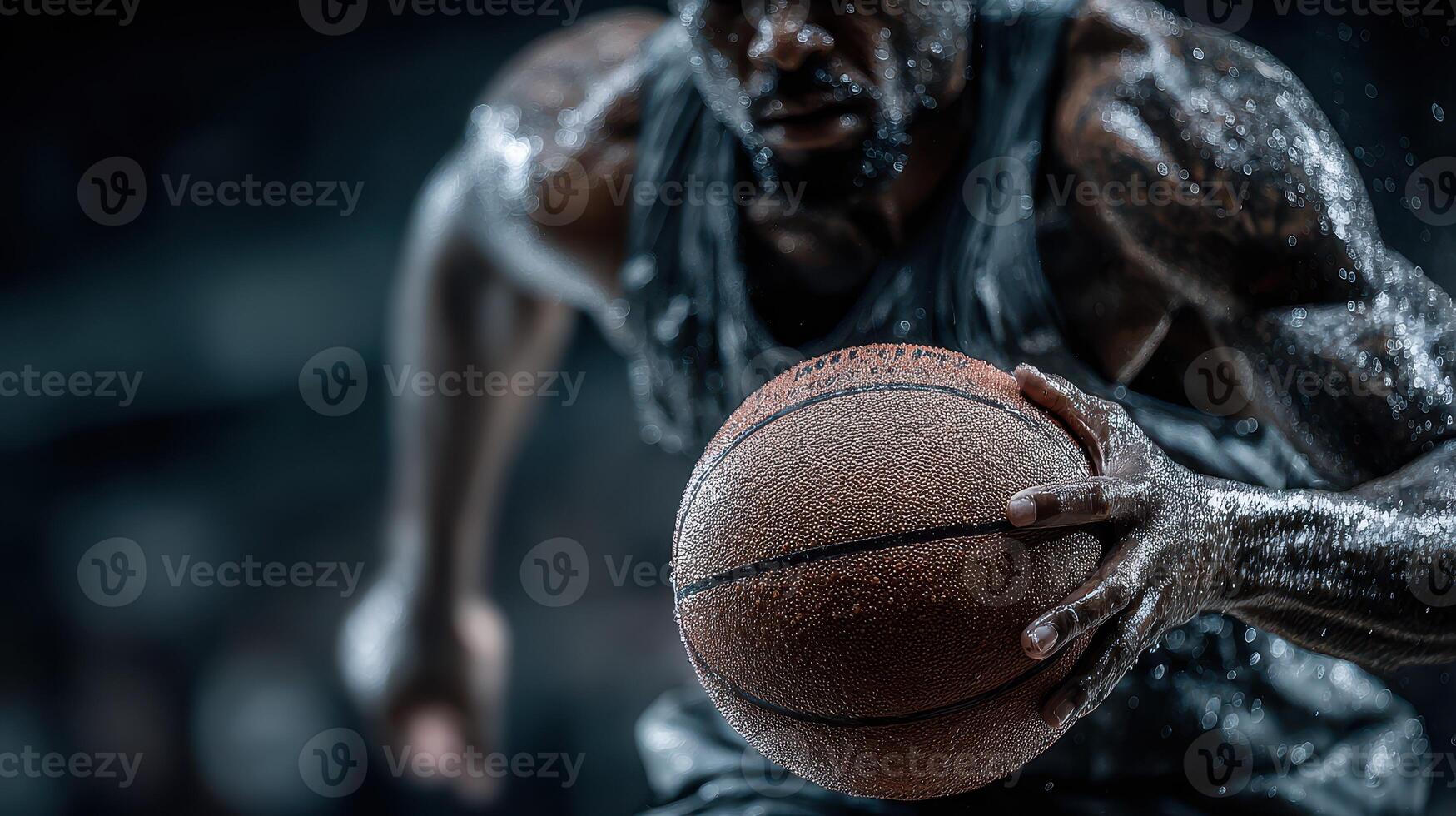 Intense basketball player dribbling through sweat during an indoor game at night photo