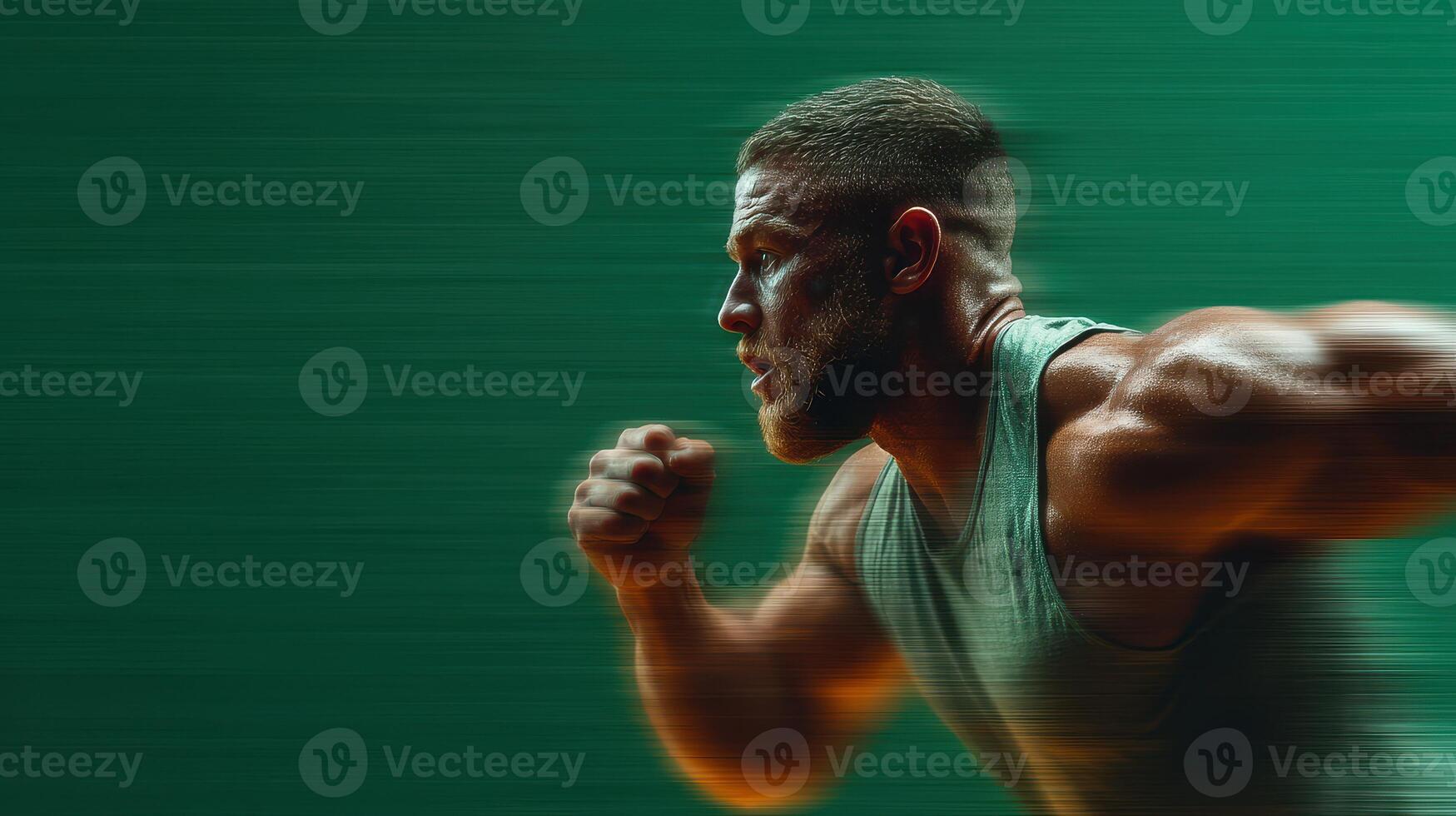 Strong man running in a powerful sprint motion on a green background during an athletic training session photo