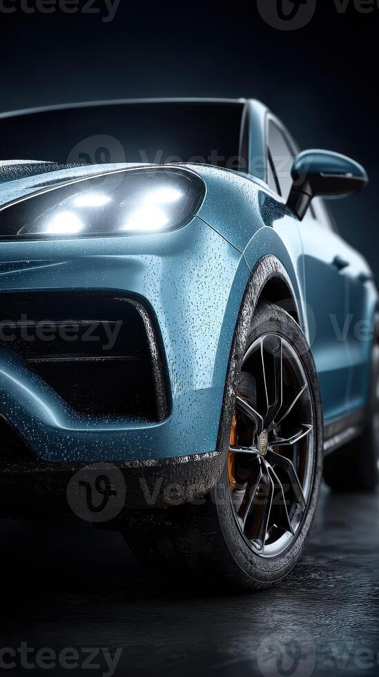 Sleek blue car with raindrops showcases modern design in moody lighting at a studio setting photo