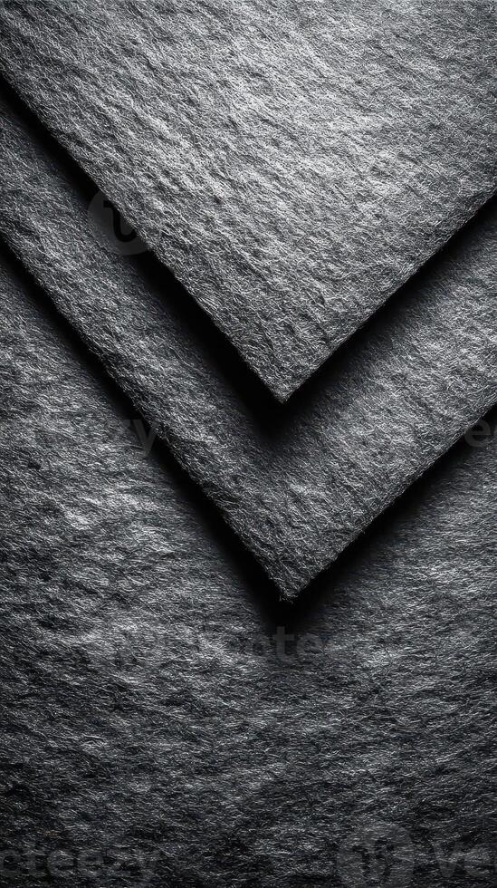 Textured black paper sheets arranged in layers highlighting intricate details of material quality photo