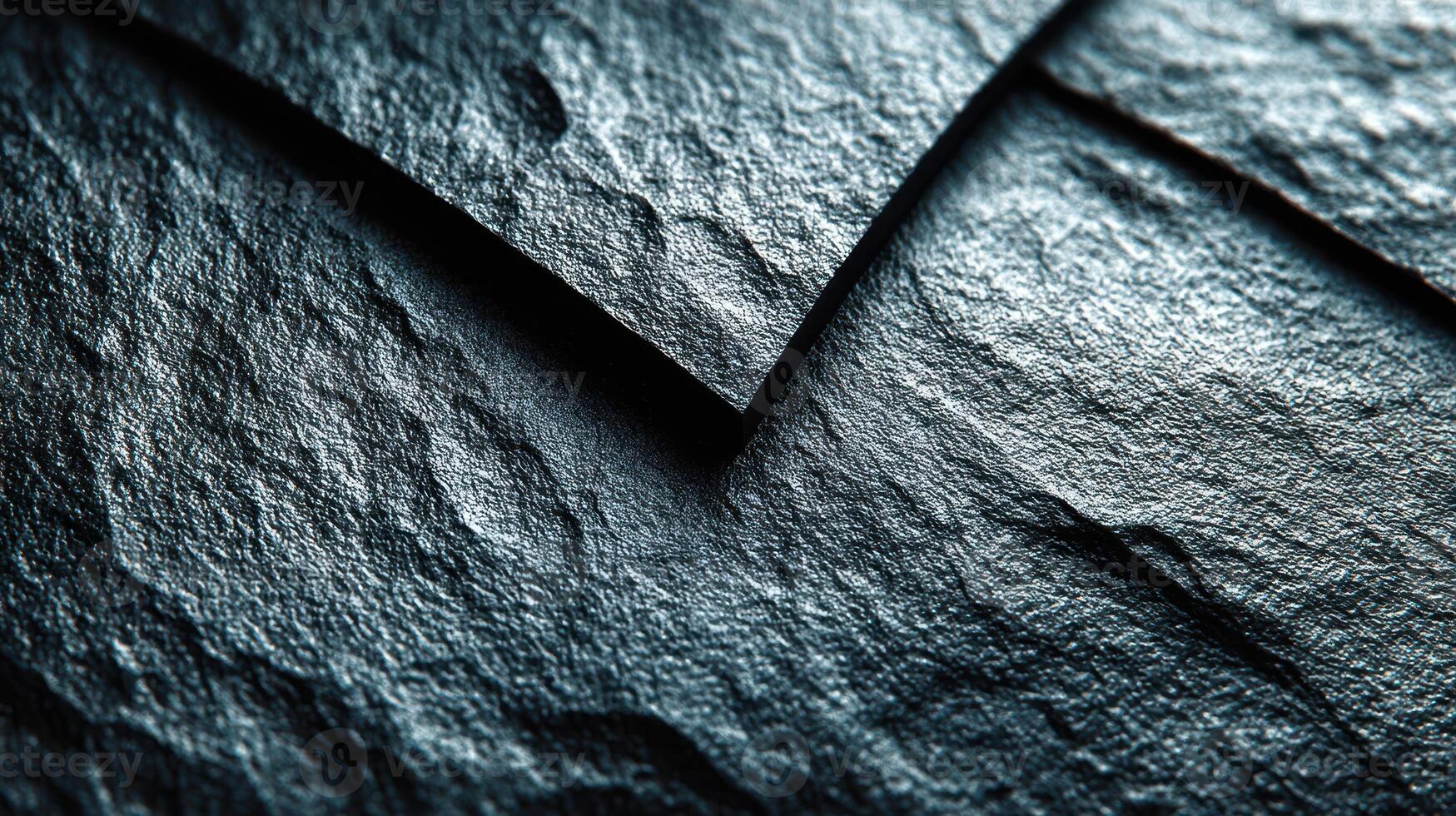Textured dark surface showcasing natural slate patterns with intricate details and variations in light during the afternoon photo