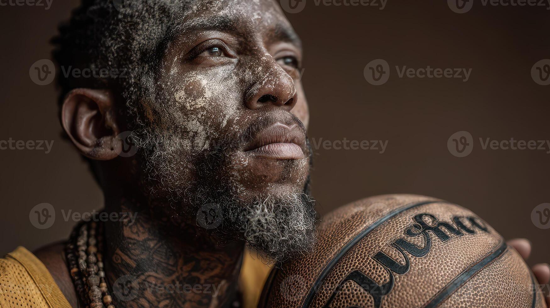 Basketball player with unique facial art holds ball, showcasing deep focus and determination in a studio setting photo
